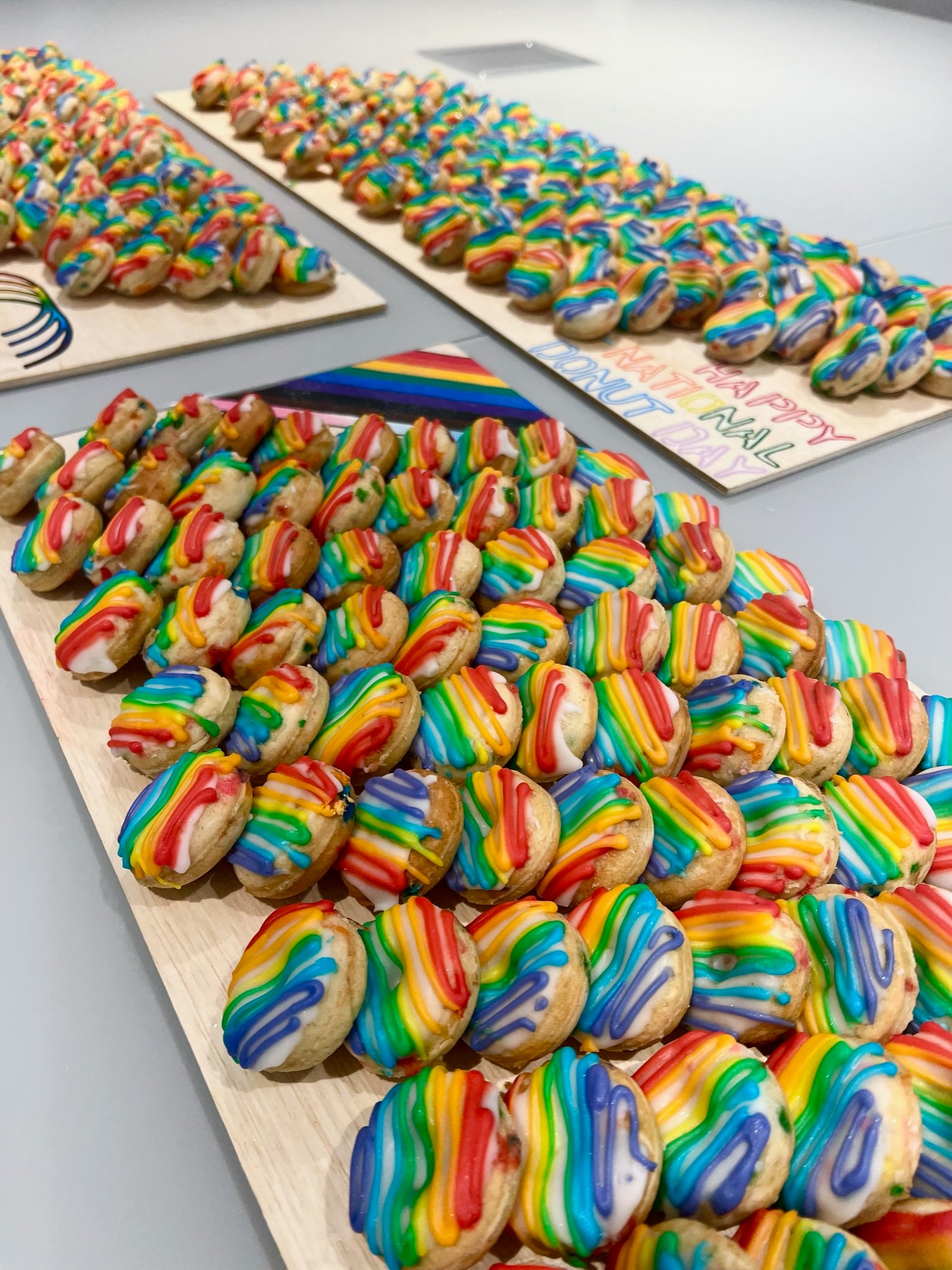 the gay donut, pride dessert, pride themed dessert, rainbow dessert, rainbow mini donuts, rainbow donut, queer owned bakery, gay owned bakery nyc, pride dessert catering nyc, office catering