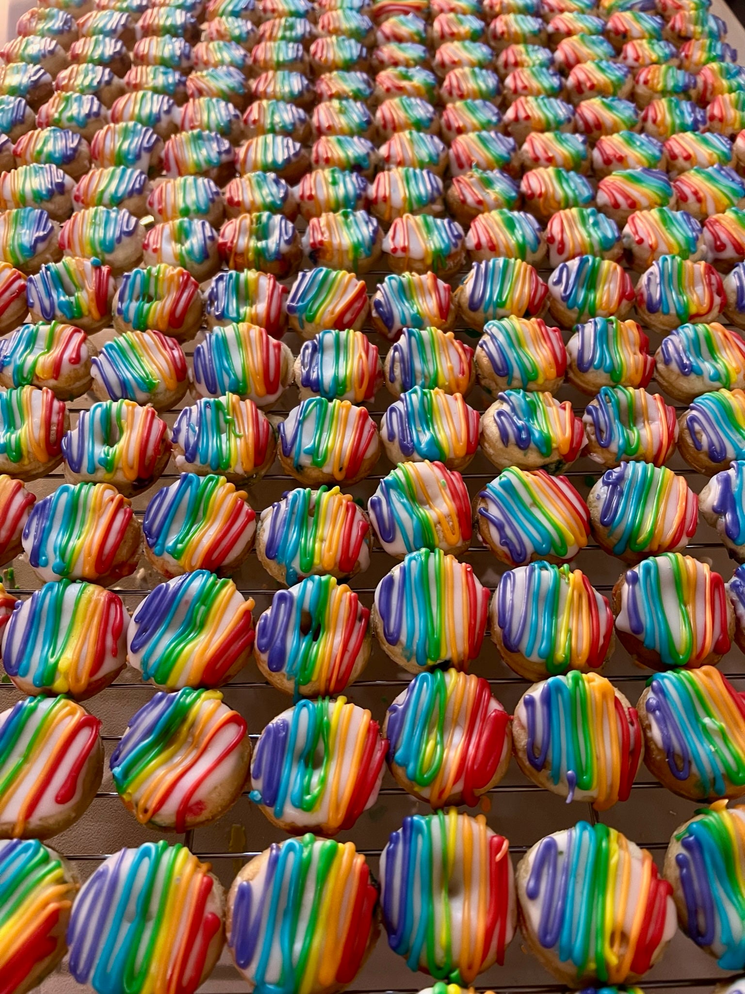 the gay donut, pride dessert, pride themed dessert, rainbow dessert, rainbow mini donuts, rainbow donut, queer owned bakery, gay owned bakery nyc, pride dessert catering nyc