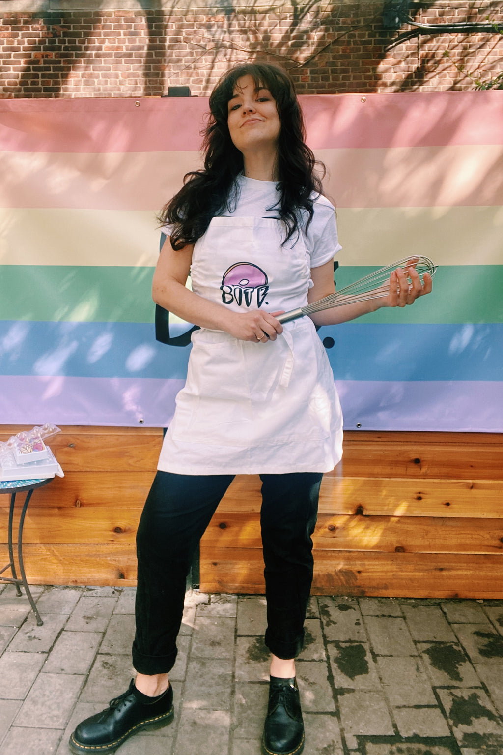 queer owned mini donut bakery in brooklyn nyc selling baked, artisan, custom, mini donuts and merchandise like aprons, hats, and t-shirts. custom dessert catering nyc